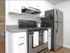 Contemporary kitchen with stainless steel oven and stainless steel refrigerator