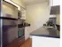 Kitchen with White Cabinets, Stainless Steel Appliances, LED Lighting and Granite Counters