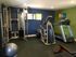 Gym photo includes a treadmill, elliptical and weight machine.