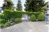 Pool Entrance with gate and lush green landscaping.