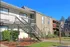 Building exterior showcasing our stairways and landings surrounded by green landscaping.