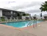 Swimming pool deck with lounge furniture.