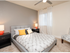 Meridian Terrace staged bedroom with ceiling fan, window streaming in natural light and two tone paint.