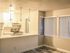 Kitchen and dining room with wood plank flooring and multiple dining room windows.
