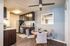 Dining area with ceiling fan, leading into kitchen.