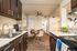 Kitchen with goose neck faucet and dark cabinetry.