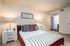 Large bedroom furnished with model furniture.