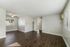 grey walls, vinyl plant flooring, windows and ceiling fan with wall a/c unit