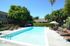 Sparking pool with blue skies and green trees