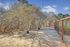 Within the premises of the apartment complex, a fenced area features trees and a dirt path for tranquil walks.