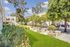 Courtyard at Footprints on the Bay apartment complex, featuring lush greenery and seating areas.