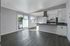 Open concept dining room and kitchen with view to patio.