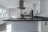 Kitchen stove with modern hardward on cabinets.