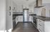 Kitchen with stainless steel appliances and white cabinetry.