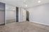Bedroom with large mirrored closet and built in shelving.