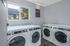 Well kept laundry facility with new machines and window.