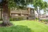 green landscaping with redwood tree and cypress tree outside of apartment community with monument sign