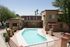 Ariel view of pool and leasing office back entrance. pool is gated with rust colored gate.
