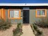 The front of the leasing office at Blacklidge Flats, a small building with orange trim.