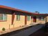 Image of Hedrick Flats property exterior, showcasing a pathway to each individual flat.
