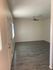 Empty living room with hardwood floors and a ceiling fan in the stylish Hedrick Flats.