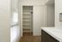 A bathroom featuring closet and plenty of shelving space