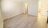 A Spacious room with light hardwood flooring.