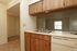 A kitchen with wood cabinets and a white dishwasher