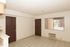 Clean, empty room with white walls and tiled flooring at The Edison Apartments.