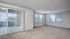 Spacious apartment with carpet and plank flooring and large windows