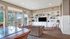Resident clubhouse with seating, a TV area, and community kitchen