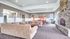 Resident clubhouse with seating, a TV area, and community kitchen