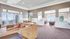 Resident clubhouse with seating, a TV area, and community kitchen