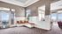 Resident clubhouse with seating, a TV area, and community kitchen