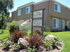 Front of La Loma Terrace apartment building with sign directing to leasing office