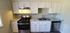Stylish kitchen in Sierra Oaks showcasing white cabinets and stainless steel appliances and gooseneck faucet