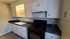 White cabinets, black stove, and sink in a Sierra Oaks kitchen