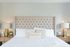 bedroom with bedframe and two night stands. lamps and decor on each night stand creating a cozy environment
