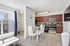 View into Dining room and kitchen. cherry oak colored cabinets giving the kitchen a warm feel. stainless steel appliances and window to the left peering onto the front patio