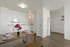 white kitchen, white appliances, white cabinets, vinyl flooring and dining table