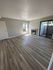 vinyl flooring with fire place. patio door on right side of fireplace