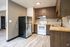 stainless steel fridge, white stove, tile backsplash, and butcher block counters