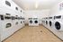 "A laundry facility equipped with seven washers and eight dryers, providing ample space for laundry needs