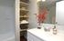 A modern bathroom showcasing a sink, shower, and toilet, emphasizing a sleek and organized space.