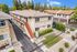Aerial view of a residential neighborhood showcasing a street lined with houses and a visible sidewalk.