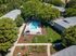 ariel view of community's parking lot surrounded by trees