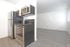 A modern kitchen featuring stainless steel appliances, including a sleek microwave, showcasing a contemporary design.