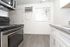 A modern kitchen featuring stainless steel appliances, including a sleek microwave, showcasing a contemporary design.