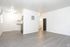 A bare room with elegant hardwood floors and stark white walls, offering a minimalist and spacious environment.