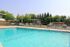 A tranquil pool nestled within a park, offering a peaceful retreat amidst vibrant trees and natural beauty.